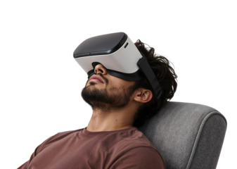 Relaxed young man experiencing virtual reality with modern vr headset while sitting on comfortable chair, isolated on the transparent background