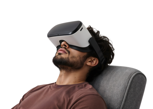 Relaxed young man experiencing virtual reality with modern vr headset while sitting on comfortable chair, isolated on the transparent background