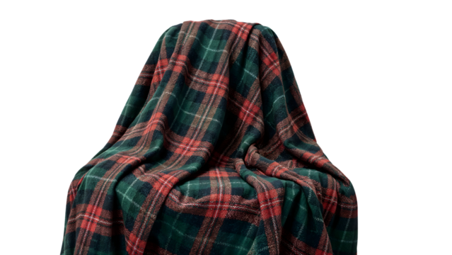 Plaid tartan blanket draped on chair isolated on white, cozy warm winter textile pattern, red and green checkered fabric comfort decor