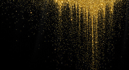 Fototapeta premium Sparkling golden glitter cascades against a deep black background, creating a luxurious and festive atmosphere for celebrations.
