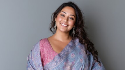 Fototapeta premium Plus-size woman wearing traditional Indian saree, smiling confidently in studio 