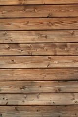 Vertical view of stacked pale wooden boards showing clean surface, natural wood grain. Ideal material for building, furniture making, interior finishes, woodworking projects.