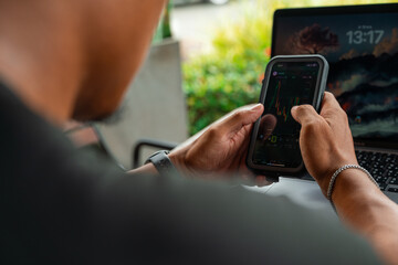 Professional using notebook and smartphone in a cafe setting, representing business, trade, finance, remote working, and productivity in a modern workspace lifestyle.