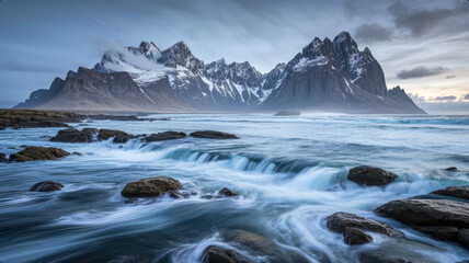 Obraz premium Winter Snowy Mountain with Ocean Waves and Rocks, 