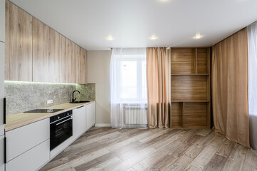 wood cabinets, white lowers, stone backsplash, dark fixtures, wood floors, bright window, and stylish shelving