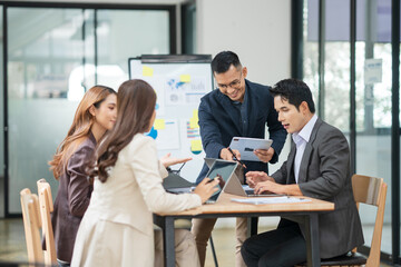 Asian business group meets to explain presentations and plan business and investment projects.
