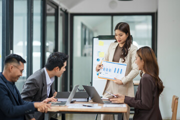 Asian business group meets to explain presentations and plan business and investment projects.