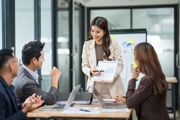Asian business group meets to explain presentations and plan business and investment projects.