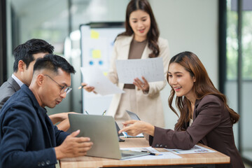 Asian business group meets to explain presentations and plan business and investment projects.