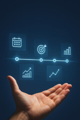 Hand holding digital business icons with calendar, target, and graph symbols glowing