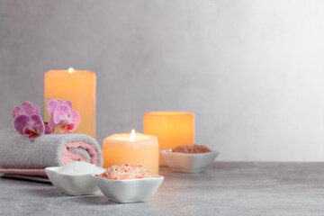 Sea salt, towels, orchid flowers, and burning candles.