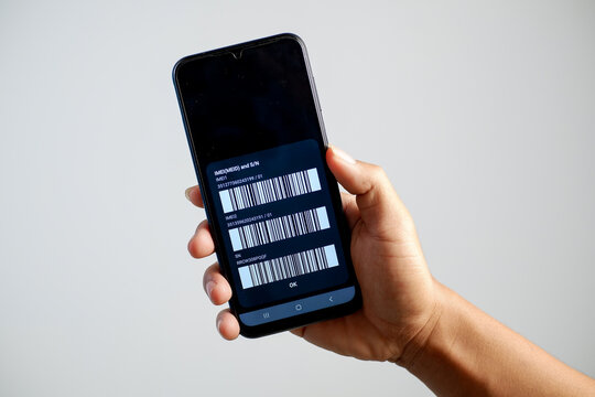 Detailed photo of IMEI code on mobile phone screen in hand isolated on white background.