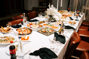 Elegant dining setup with a variety of dishes at a festive gathering in a cozy atmosphere
