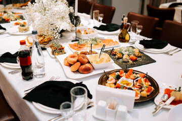 Elegant dining setup with a variety of dishes at a formal gathering in an upscale location