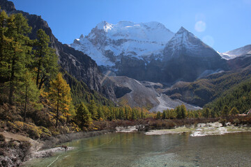 Majestic snow peaks tower over serene alpine rivers and lakes  Yading Nature Reserve, Sichuan, China