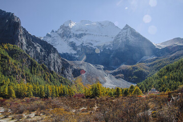 Majestic snow peaks tower over serene alpine rivers and lakes  Yading Nature Reserve, Sichuan, China