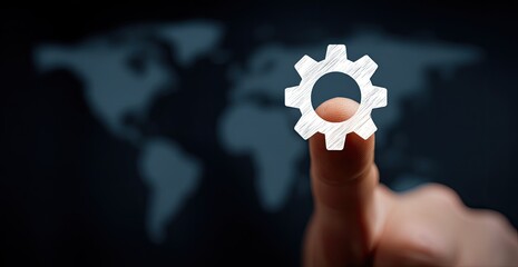 A finger points to a sketched gear icon over a world map background