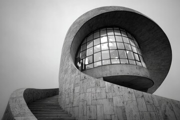 Modernist concrete structure, curved walls, spiral staircase