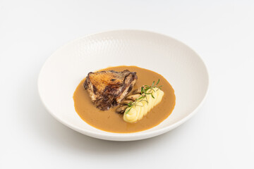 Roasted meat with mashed potatoes and brown sauce on plate