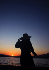 muslimah woman traveling to beach, enjoy the sunset, orange colour