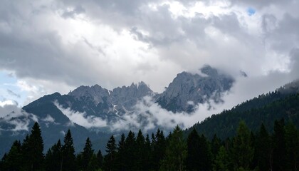 Mountain peaks shrouded in a moody, overcast sky