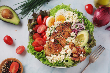 A bowl with cobb salad, traditional American dish