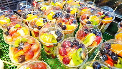 Vibrant Fruit Medley Cups: A delightful array of colorful fruit cups bursting with an enticing selection of fresh, seasonal fruits. Capturing the essence of healthy eating and culinary charm.