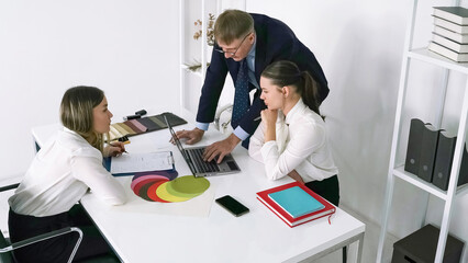 Collaborative business meeting in a modern office setting with team discussing project plans