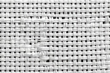 Close-up view of a white, tightly woven fabric with a crisscross pattern