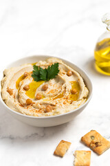 Homemade vegan hummus. Tasty vegan snack. Light background.
