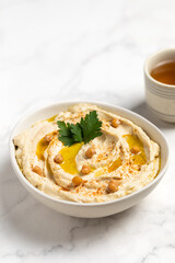 Homemade vegan hummus. Tasty vegan snack. Light background.