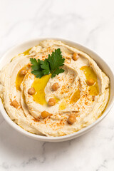 Homemade vegan hummus. Tasty vegan snack. Light background.