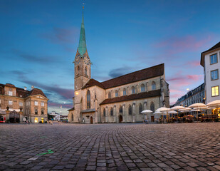 Zurich, Switzerland. View of Fraumunster Church (Kirche Fraumunster) at dusk and Munsterhof square