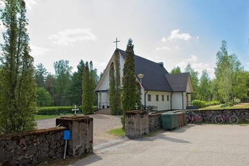Old chapel at Taavetti cemetery in spring with clouds in the sky, Taavetti, Finland.