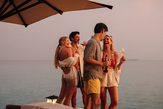 Family enjoying a luxurious holiday at the beach, celebrating special times together - Powered by Adobe