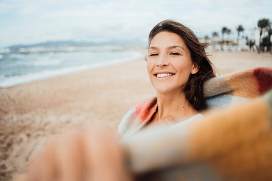 Smiling woman spending leisure time at beach