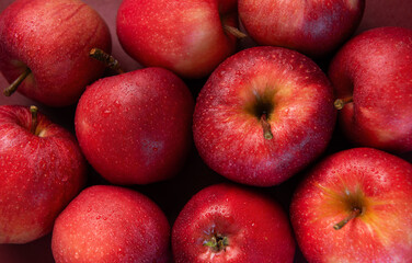 Fresh red apples forming appealing composition on dark background