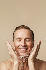 Senior man washing face for skin care and beauty routine with fresh water splash
