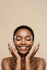 African American woman washing face for skin care and beauty routine with fresh water splash