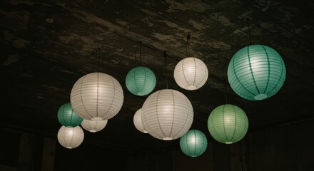 Obraz premium A cluster of paper lanterns hanging from a concrete ceiling.