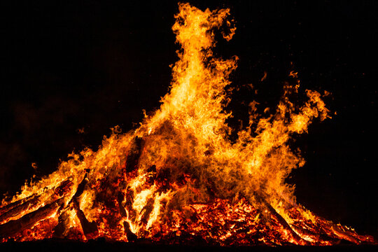 Large bonfire burning at solstice celebration