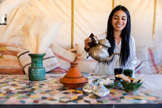 Pouring Moroccan tea in a luxury tent interior in the Sahara desert