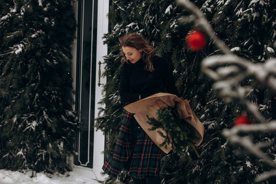 A woman walks along a city street on Christmas Eve in search of gifts and a good mood