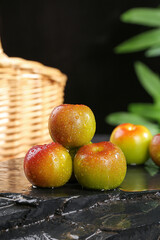Fresh Red Plums with Water Droplets on Slate Stone Surface