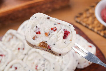 Traditional Poria Cake with Nuts and Dried Fruits - Healthy Chinese Ancient Dessert on Wooden Table