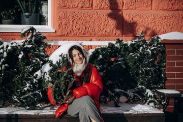 A woman walks along a city street on Christmas Eve in search of gifts and a good mood