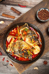Chinese Braised Fish Head Casserole with Soy Sauce and Chopped Peppers in Traditional Clay Pot