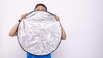 Man Hiding Behind Photography Reflector with Surprised Expression