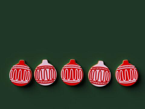 Christmas cookies arranged in a row on green background