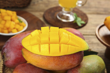 Fresh Hainan Guifei Mango Cubes with Coconut and Tropical Fruits on Wooden Table